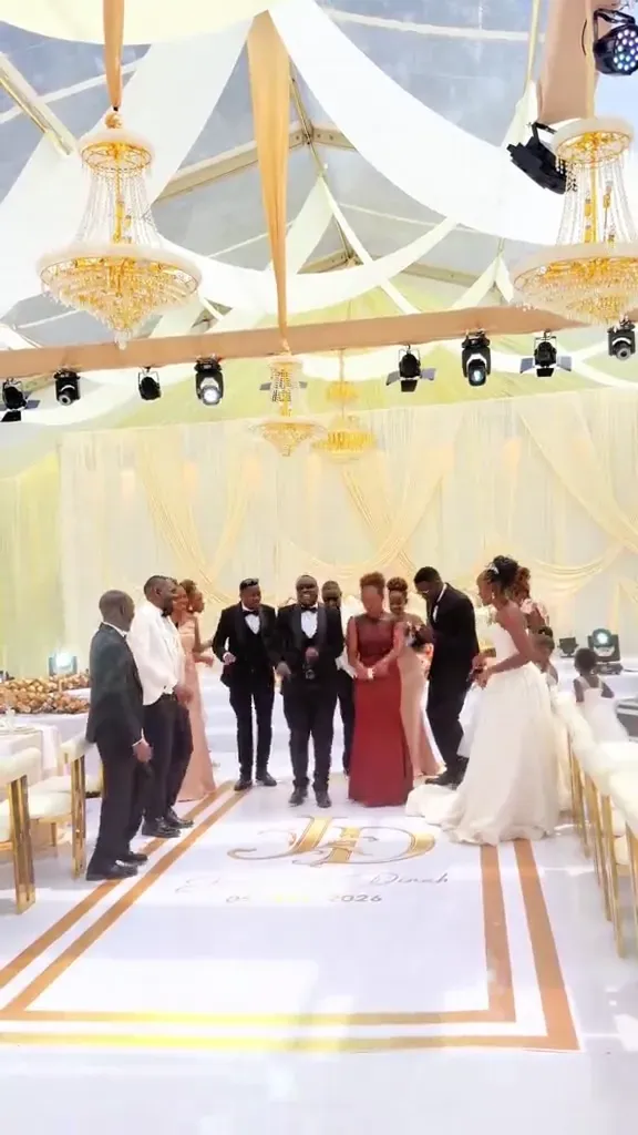 A wedding reception dressed and lit, seen across the room.